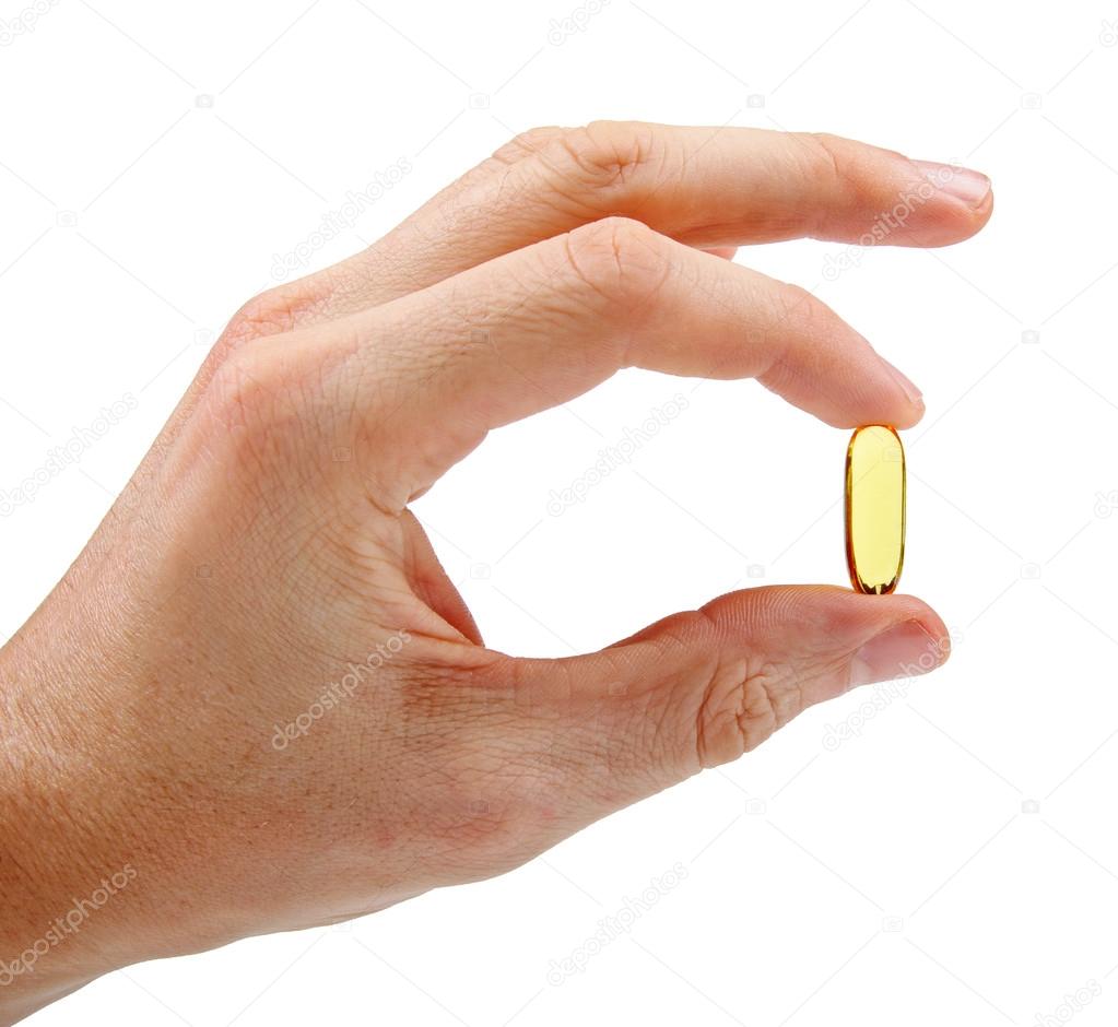 hand with fish oil capsule isolated on white