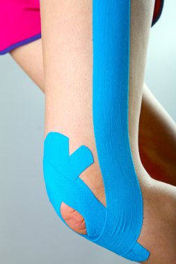 physiotherapy - knee with blue kinesio tape clipart