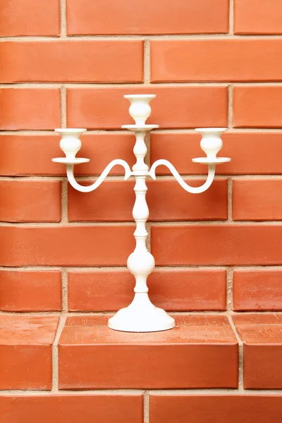 White candlestick on the brick background — Stock Photo, Image
