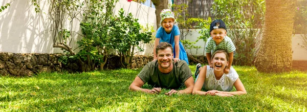 Happy Family Two Children Lying Home Backyard Garden Lawn Looking — Stock Photo, Image