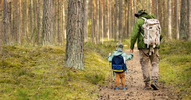 father and son on a adventure hike in forest. bonding activities, nature explore