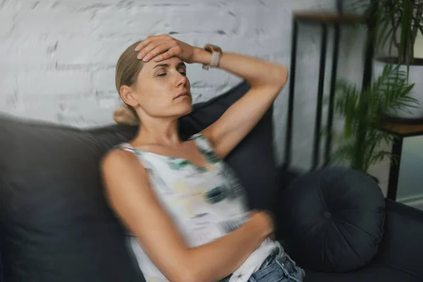 Woman Having Migraine Headache Home Sitting Couch Hand Forehead — Stockfoto