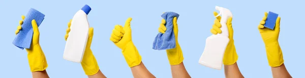 Hand Yellow Rubber Glove Holding Cleaning Supplies Isolated Blue Background — Fotografia de Stock