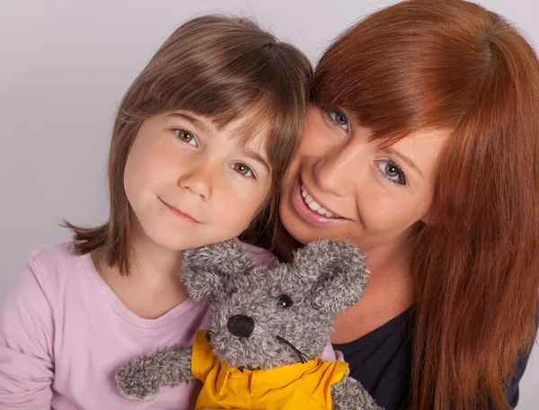 A young mother is cuddling with her daughter — Stock Photo, Image