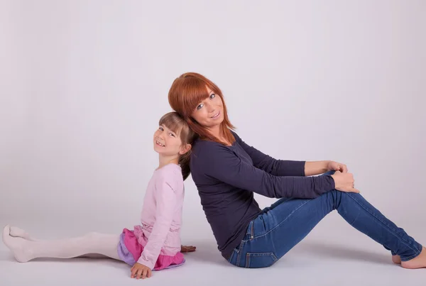 A young mother neck and neck with her daughter — Stock Photo, Image