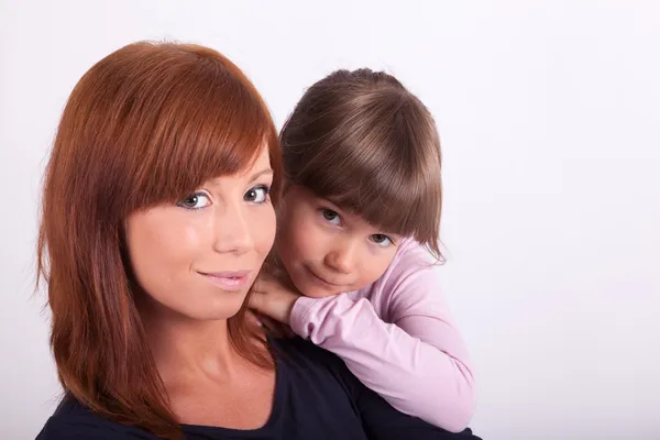 A young mother is cuddling with her daughter — Stock Photo, Image