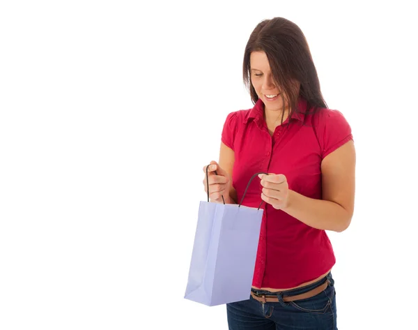 The young girl is looking into a shopping bag — Stock Photo, Image