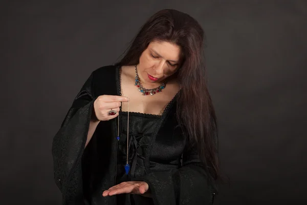 A woman is working with a pendulum — Stock Photo, Image