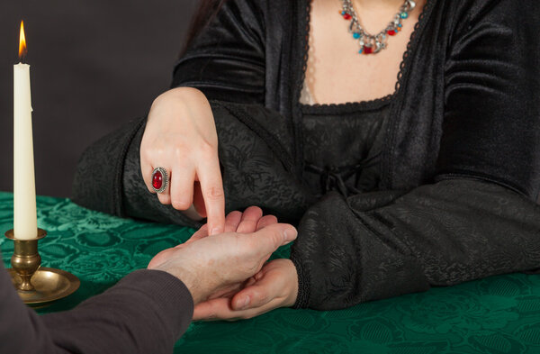 A woman is doing a palm reading