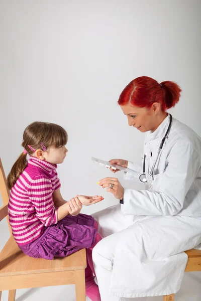 The pediatrician gives her patient a tablet — Stock Photo, Image