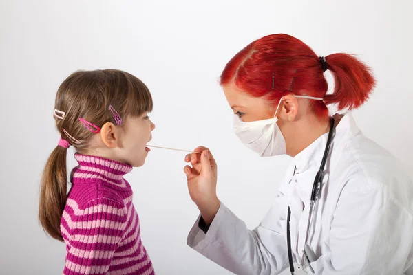 Le pédiatre regarde une petite fille dans la bouche — Photo