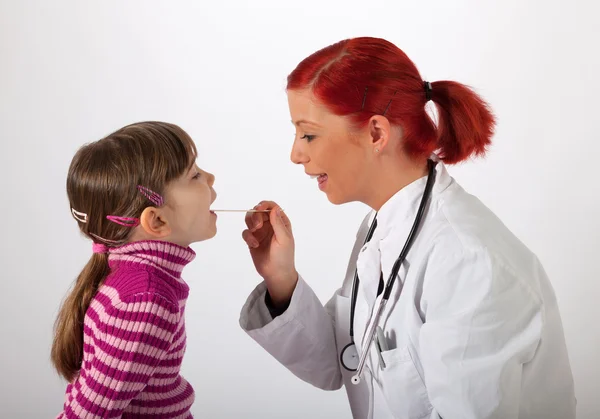 Le pédiatre regarde une petite fille dans la bouche — Photo