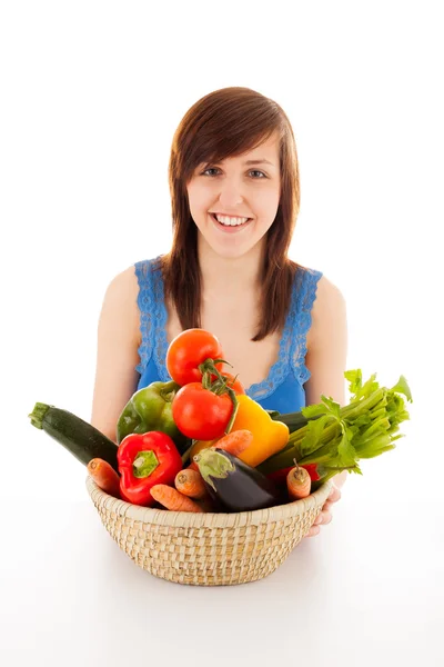 Une jeune femme avec un panier plein de légumes — Photo