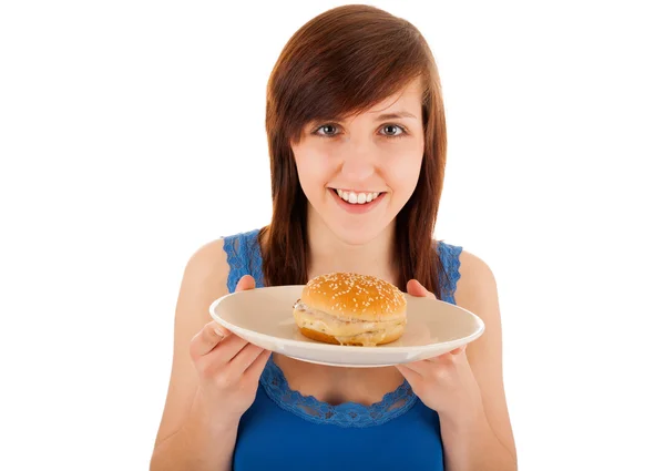 The young woman is eating a cheeseburger — Stock Photo, Image