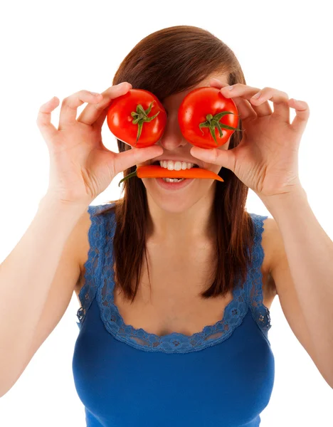 The young woman is covering her eyes with tomatoes — Stock Photo, Image
