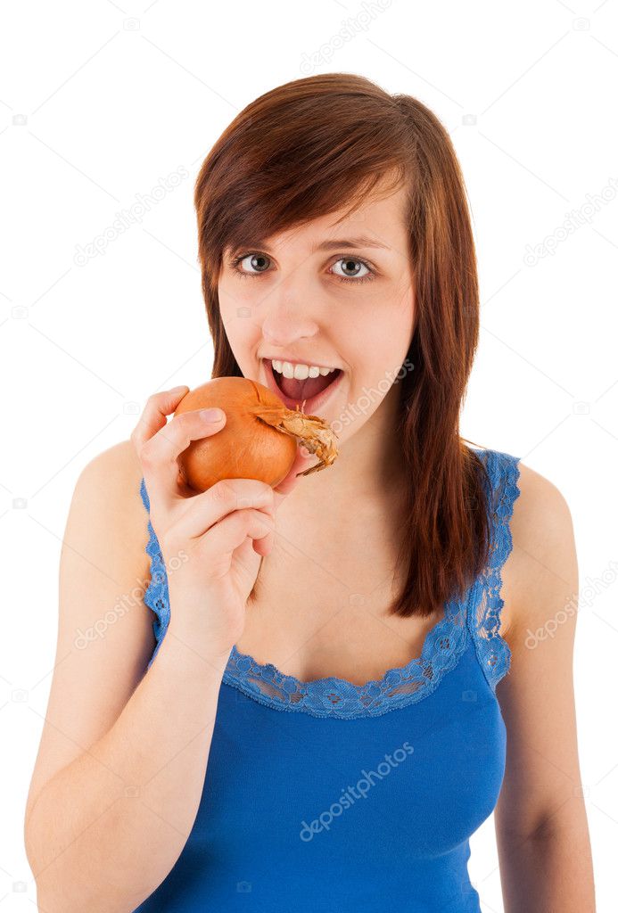 The young woman bites into an onion