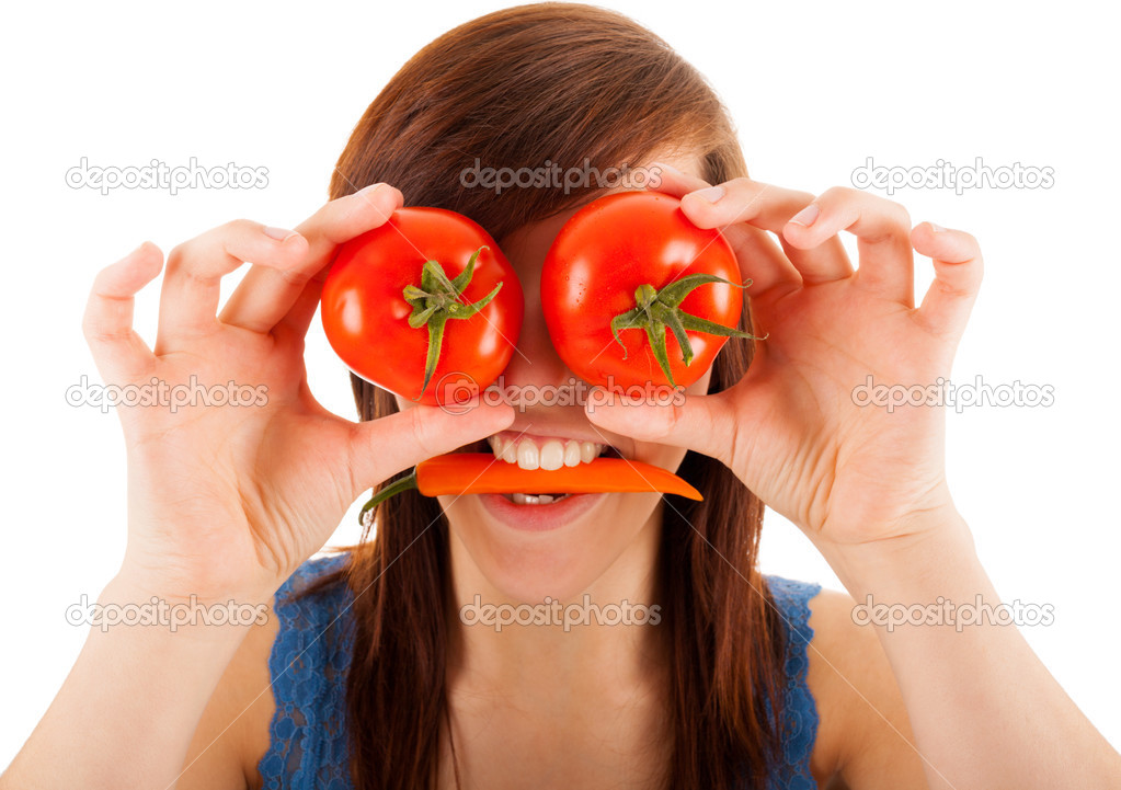 The young woman is covering her eyes with tomatoes