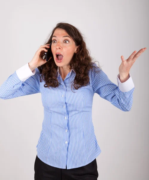 The young business woman is on the phone with her mobile phone — Stock Photo, Image