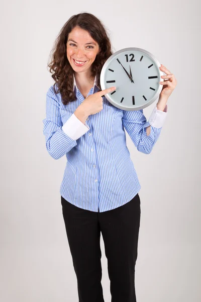 Молода бізнес-леді тримає великий годинник в руках — стокове фото