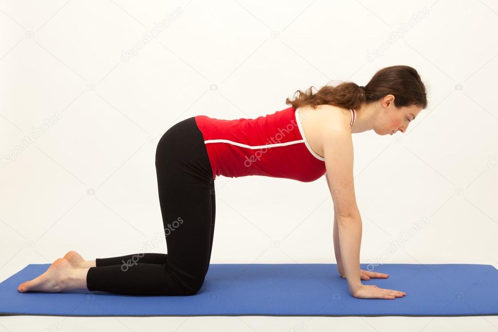 The young woman is exercising on a mat
