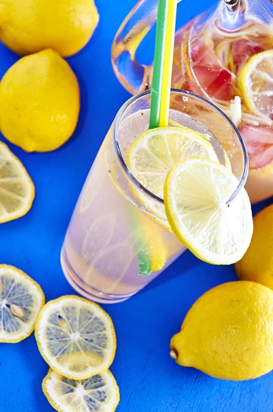 Ice cold lemonade in a glass with pithcer — Stock Photo, Image