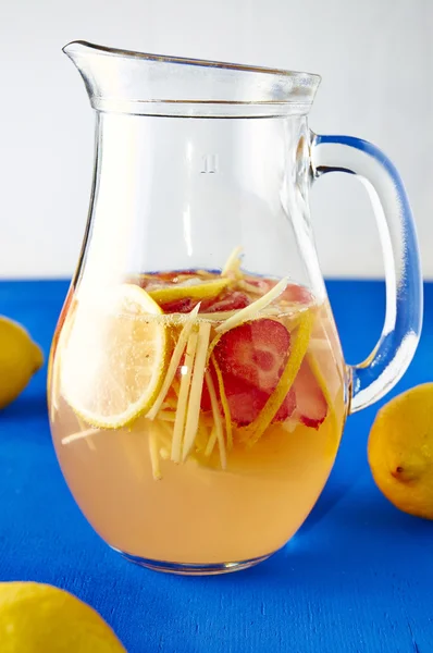 Fresh ginger lemonade with strawberry in pithcer — Stock Photo, Image