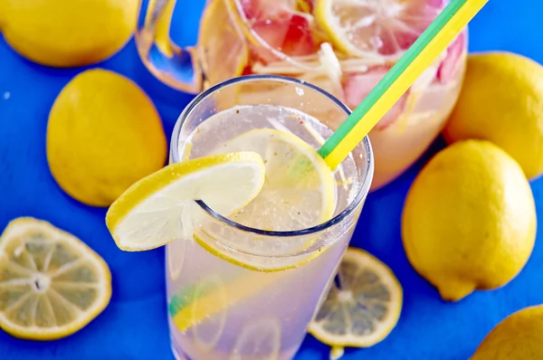 Ice cold lemonade in a glass with pithcer — Stock Photo, Image