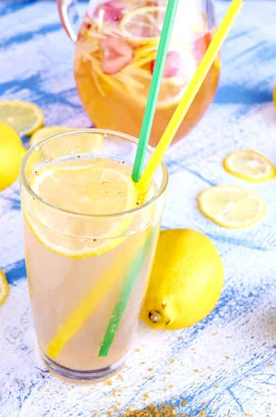 Ginger lemonade in glass with pithcer on back. — Stock Photo, Image
