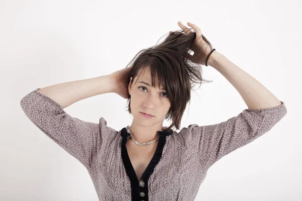 Porträt einer jungen Frau, die mit ihren Haaren spielt — Stockfoto