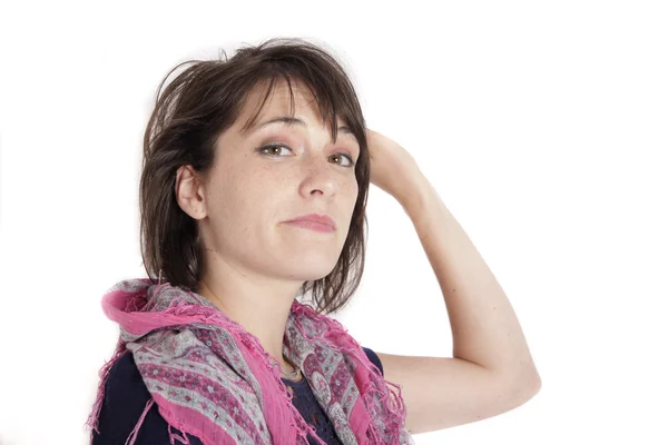 Young brunette woman playing with her hair isolated on studio — Stock Photo, Image