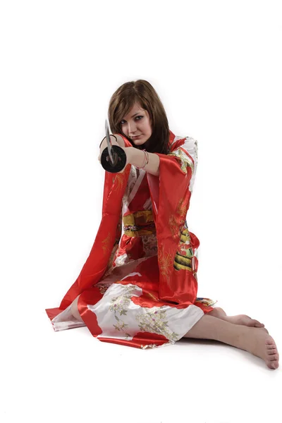 French young girl geisha in red silk kimono with japanese sword — Stock Photo, Image