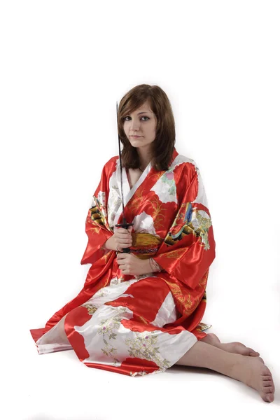 French young girl geisha in red silk kimono with japanese sword — Stock Photo, Image