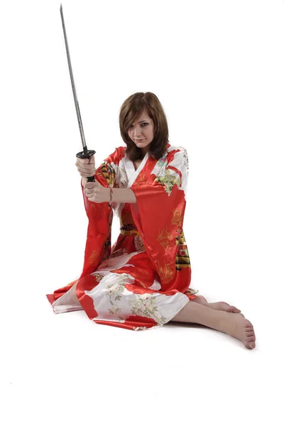 French young girl geisha in red silk kimono with japanese sword — Stock Photo, Image