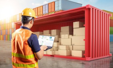 Engineer or asian worker work with computer notebook at container terminal