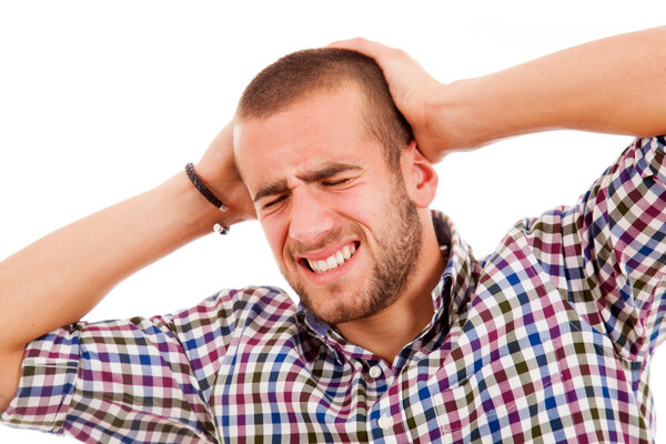 Casual young man with a headache on a white background