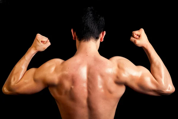 Espalda muscular del macho sano sobre fondo negro . —  Fotos de Stock