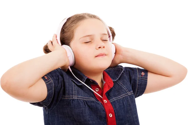 Cute blonde little girl enjoying music using headphones, isolate — Stock Photo, Image