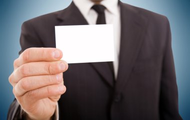 kartvizitini gösterilen takım elbiseli bir adam iş