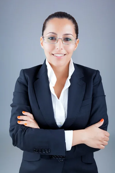 Portrait of beautiful business woman wearing glasses against gre — Stock Photo, Image