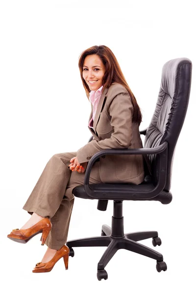 Portrait of beautiful young woman sitting on chair isolated over — Stock Photo, Image