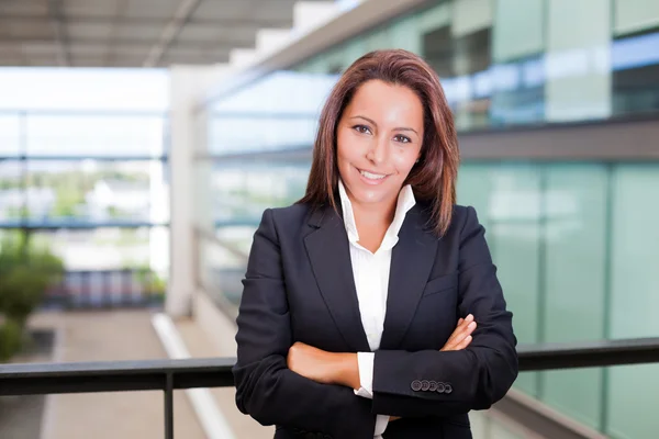 Smiling young business woman at the office — Stock Photo, Image
