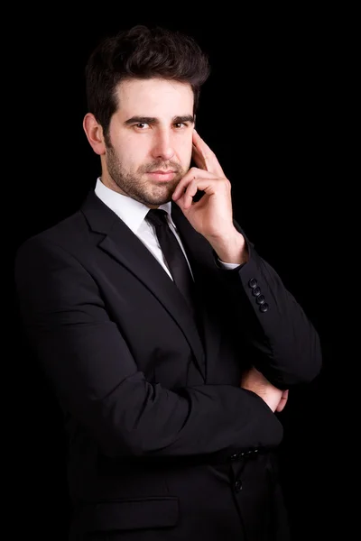 Guapo joven hombre de negocios retrato sobre fondo negro —  Fotos de Stock