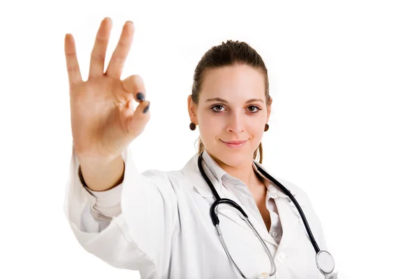 Young doctor signaling OK against white background — Stock Photo, Image