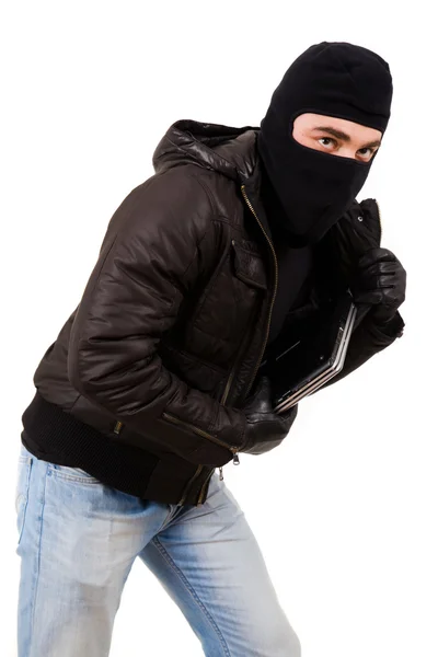 Thief holding a laptop, isolated over white background Stock Image