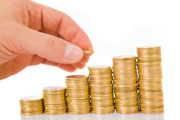 Hand put coin to money staircase, isolated on white Stock Picture