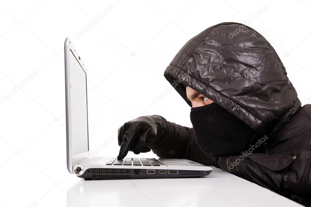 Computer Hacker stealing information from a laptop, isolated ove