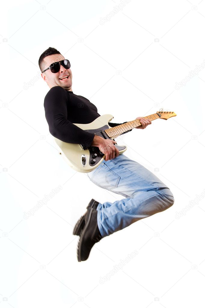 casual man playing an electric guitar and jumping