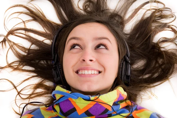 Woman lying on floor and listening to music — Stock Photo, Image