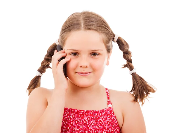 Smiling little girl talking on a cell phone, isolated on white — Stock Photo, Image