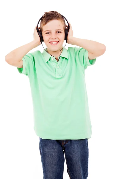 Happy young boy listening to music on headphones against white b — Stock Photo, Image